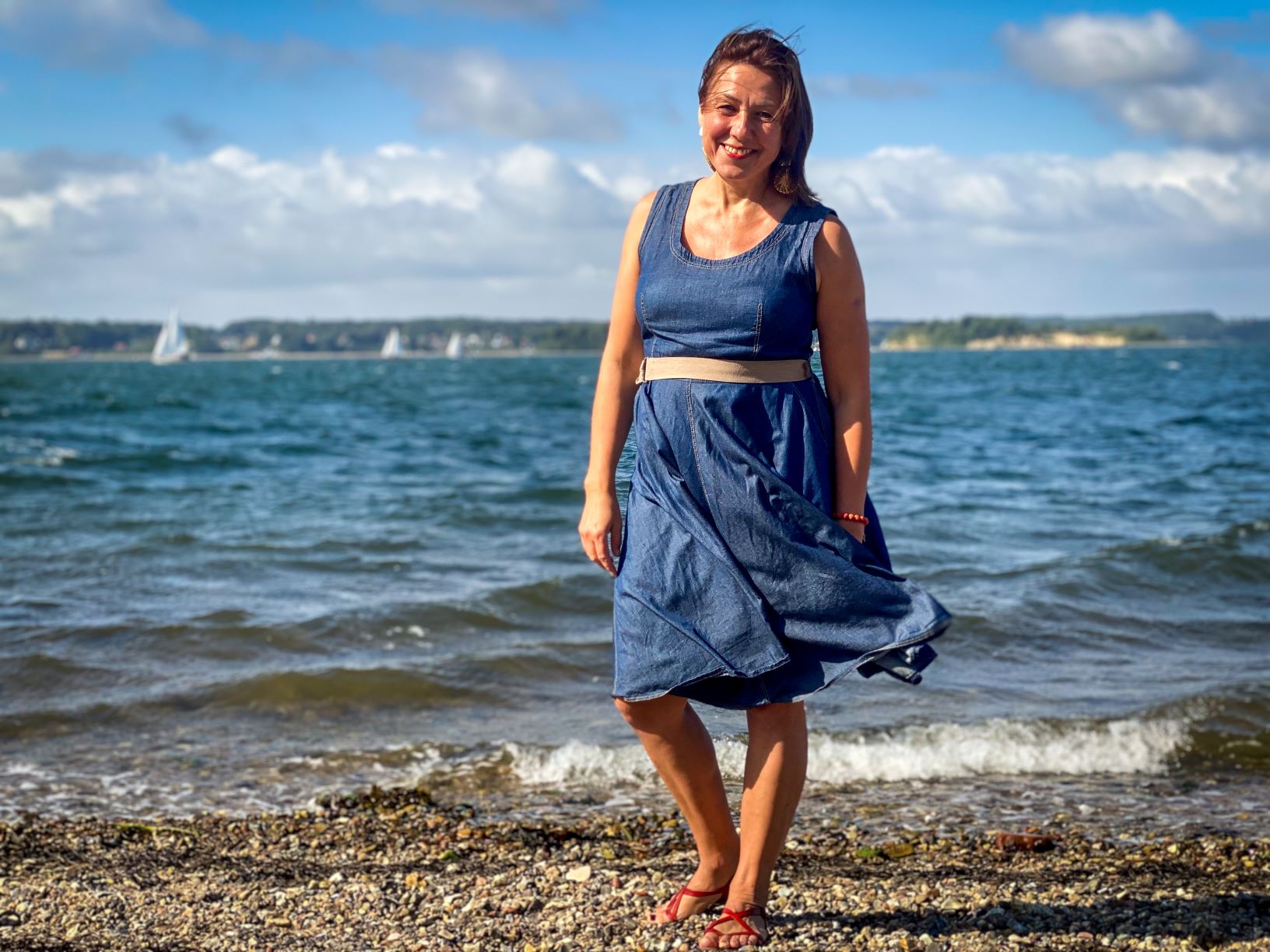 Woman standing on a windy beach